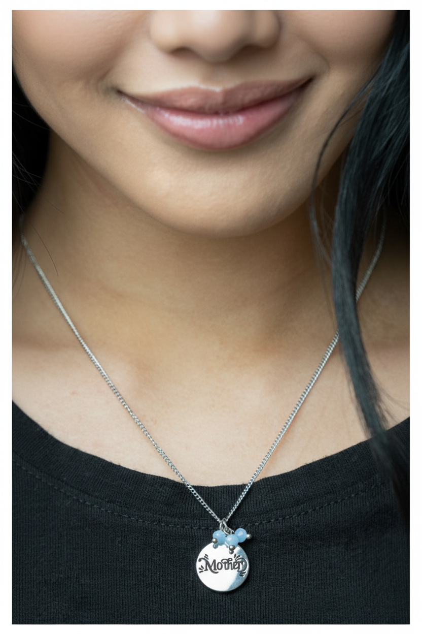 Asian woman wearing Mother disc necklace with cerulean beads