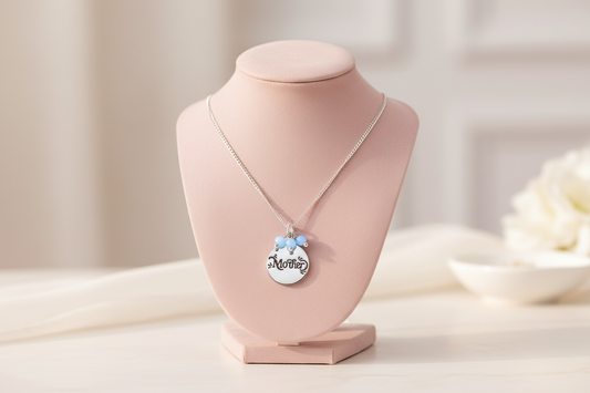 Mother disc necklace with cerulean beads on blush vanity